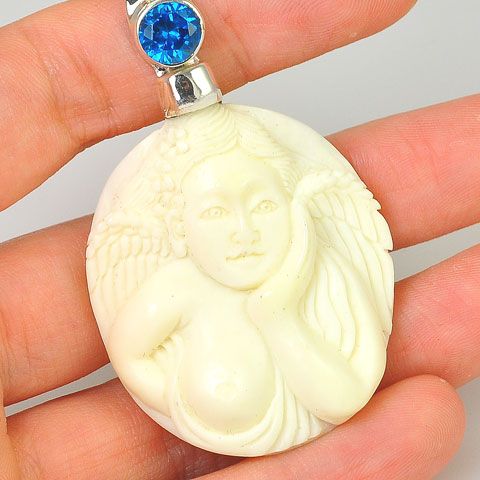 Sterling Silver Carved Bone Angel and Blue Topaz Pendant