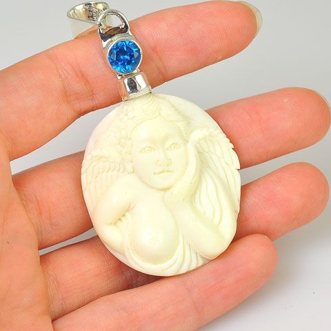 Sterling Silver Carved Bone Angel and Blue Topaz Pendant