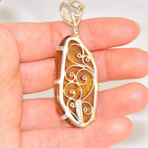 Sterling Silver 35.4-Carats Carved Amber Buddha Face and 0.5-Carats White Topaz Pendant